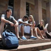 Students sit outside