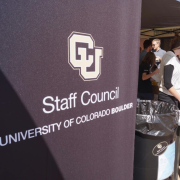 A CU Boulder Staff Council banner at an outdoor Staff Council fair. 