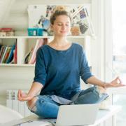 person meditating on desk