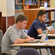 Students on laptops at Norlin Library