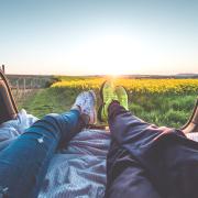 two people sitting with view of yellow flowers