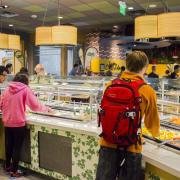 Students fill their plates in a campus dining hall