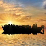 Silhouette of people on a boat at sea