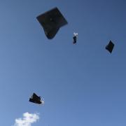 Graduation mortarboards being thrown into the air