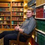 Portrait of Nick Zyzda at the stacks in Norlin Library