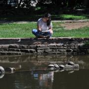 Student studying by Varsity Lake.