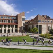 Campus community members walking by the Visual Arts Complex on campus