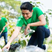 young people cleaning up trash outside