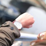 Woman checks the time on wrist watch