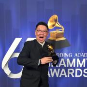 College of Music alumnus Wei Wu poses for photo with Grammy Award