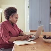 A woman working at a laptop