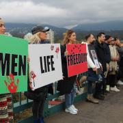 Women, Life, Freedom signs held by protestors