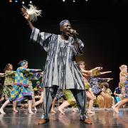 Black man leading an African dance performance