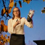 Madalyn Kern (MechEngr’12; MS’14; PhD’16) holds up a prototype of an adjustable-fit prosthetic leg that she is designing and manufacturing during her talk. Photo by Glenn Asakawa.
