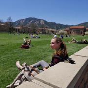 Cora Bradley, a junior chemical and biological engineering major from Annapolis, MD, enjoys the sun and warmth at Farrand Field. Photo by Glenn Asakawa.