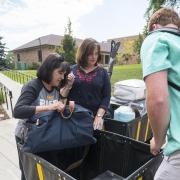 Yvonne DiStefano, wife of Chancellor Phil DiSteno, helps with move-in at Williams Village