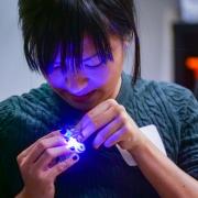 Boulder resident Alica Poon makes an LED-light unicorn pin at one of the ATLAS Research Showcase project areas. Photo by Glenn Asakawa.