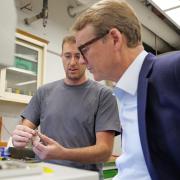 Sen. Michael Bennet visits with JILA researchers