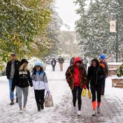 Students make their way to class during the first snowfall of the year on Oct. 10, 2019. (Photo by Patrick Campbell/University of Colorado)