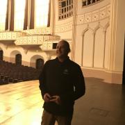  Macky Director Rudy Betancourt poses in an empty concert hall during a recent staff tour.