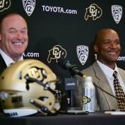 Athletic Director Rick George, left, and Karl Dorrell smile during a press conference announcing Dorrell as the new head football coach at CU Boulder. (Photo by Casey A. Cass/University of Colorado)