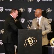 New CU football head coach Karl Dorrell, right, shakes hands with Athletic Director Rick George introduces him at a press conference at the Dal Ward Center at Folsom Field. (Photo by Glenn Asakawa/University of Colorado)