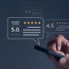Photo of hand swiping on smartphone. Bubbles appear showing 5.0, 4.9 and 4.6 -star reviews