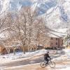 person riding a bike on a snowy campus