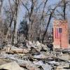 A chimney stands in the rubble of a fire