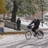 person riding a bike on snowy campus