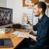 person engages with colleagues on a video call