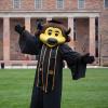 Chip the buffalo mascot in a graduation cap and gown