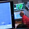 A forecaster monitors incoming data for Hurricane Irma in 2017 at the National Hurricane Center, part of the NOAA.