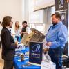 students speak with employers at a career fair