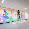 Danielle SeeWalker painting a mural