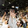 Buffs basketball fans throw newspaper confetti into the air