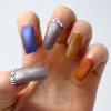 Photo of a hand with fingernails in different colors