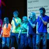 community members singing a song on stage
