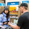 student employing helping a customer in the UPS Store on campus