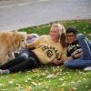 two students in Buffs gear and a dog on campus