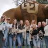 Class of 2023 graduates pose in front of a giant CU buffalo