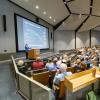 instructor lecturing in large hall