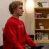 student meditating in a library on campus