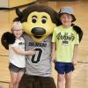 Kids pose for a photo with Chip the buffalo mascot