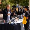 student visiting a booth at the Take Care Street Fair