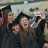 Graduates taking a selfie during commencement