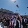 Graduates throw their caps in the air