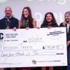 Winners hold prize checks at the New Venture Challenge championships