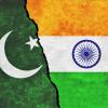 A collage of the Pakistan flag on the left (a white moon and star against a dark green background) and an India flag on the right (horizontal orange, white and green bands with a navy blue geometric circle shape in the center of the white band)en