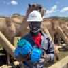 A team member holds two water quality sensors used to test for water contamination.